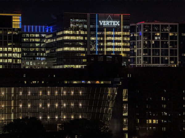 Cityscape featuring Vertex corporate office building at night, Boston