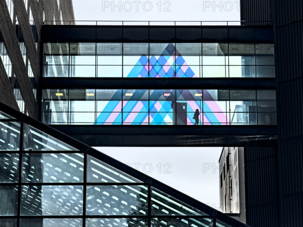 Silhouette of unidentifiable person on pedestrian bridge linking two buildings, Mount Sinai Hospital, Manhattan, New York City