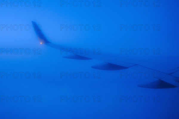Commercial airplane wing viewed from passenger window