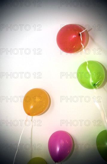 Helium-filled balloons floating to ceiling