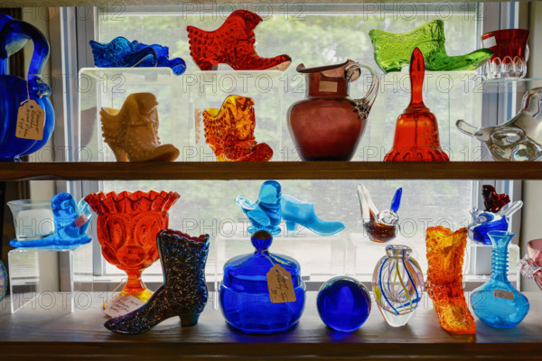 Colorful glass objects on display in antiques store