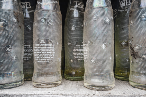 Old Tab soda bottles for sale at a roadside antique store