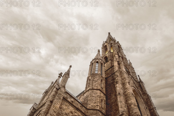Low angle view of St. Louis Roman Catholic Church, low angle view against dramatic cloudy sky, Buffalo, New York, USA