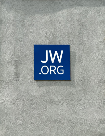 Jehovah's Witness website address on blue tile attached to cement wall