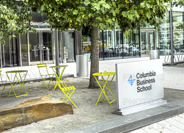 Sign and yellow bistro tables and chairs outside of David Geffen Hall, Columbia University Business School, Columbia University, Manhattanville Campus, 645 West 130th Street, West Harlem, Manhattan, New York City, New York, USA
