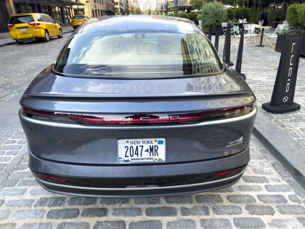 Lucid electric vehicle parked on street in front of showroom, Meatpacking District, Manhattan, New York City, New York, USA