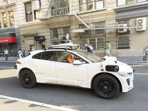 Waymo driverless test car, a Jaguar I-PACE electric vehicle and street scene, Manhattan, New York City, New York, USA