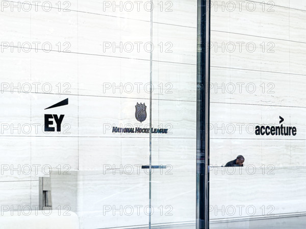 Lobby view with signs for offices of EY, National Hockey League, Accenture, One Manhattan West office building, 395 Ninth Avenue, Manhattan, New York City, New York, USA