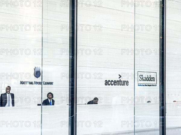 Lobby view with signs for offices of National Hockey League, Accenture, Skadden, Arps, Slate, Meagher & Flom LLP, One Manhattan West office building, 395 Ninth Avenue, Manhattan, New York City, New York, USA