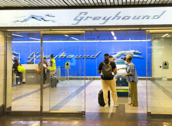 Travelers purchasing tickets at Greyhound Bus ticket office, Port Authority Bus Terminal, 625 Eighth Avenue, Manhattan, New York City, New York, USA