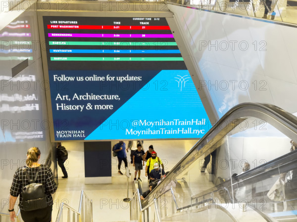 LIRR digital departure board above escalator and stairs, Moynihan Train Hall, Pennsylvania Station, Manhattan, New York City, New York, USA