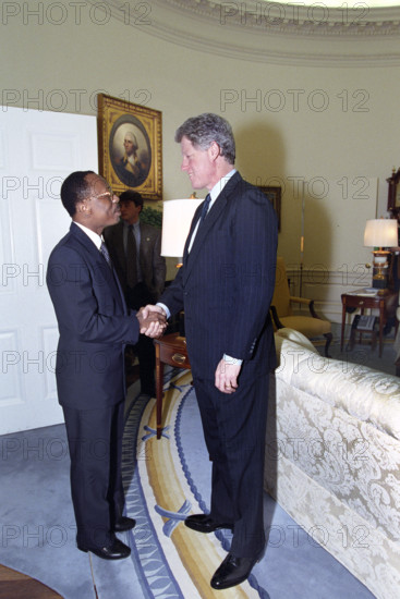 U.S. President Bill Clinton shaking hands with Haitian President Jean-Bertrand Aristide in the Oval Office of the White House, Washington, D.C., USA, Bob McNeely, White House Photographer, March 16, 1993