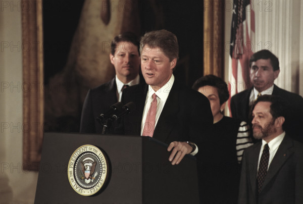 U.S. President Bill Clinton standing at podium after swearing-in the first members of his cabinet at the White House, as U.S. Vice President Al Gore and cabinet members Donna Shalala, Robert Reich and Henry Cisneros look on, Washington, D.C., USA, Barbara Kinney, White House Photographer, January 22, 1993