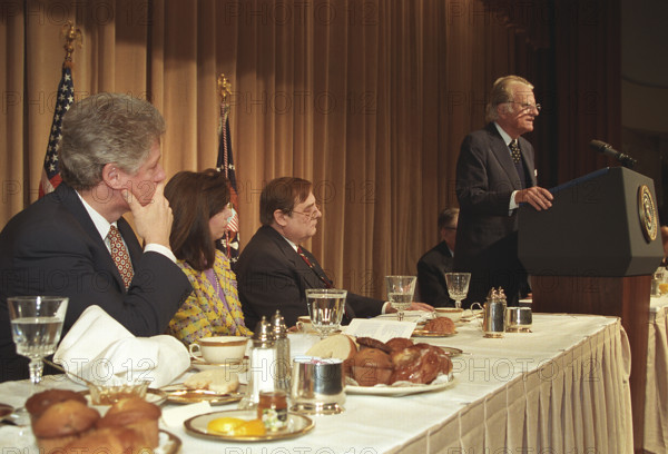 U.S. President Bill Clinton looking on as American evangelist Billy Graham is speaking at annual National Prayer Breakfast, Washington, D.C., USA, Ralph Alswang, White House Photographer, February 4, 1993