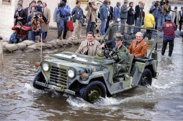 U.S. President Ronald Reagan riding in  military Jeep while touring flood damaged area, Monroe, Louisiana, USA, President Ronald Reagan White House Photographic Office, January 2, 1983