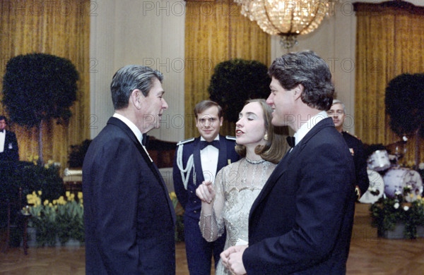 U.S. President Ronald Reagan with Arkansas Governor Bill Clinton and his wife Hillary Clinton at a dinner in honor of state governors in the East Room of the White House, Washington, D.C., USA, President Ronald Reagan White House Photographic Office, February 27, 1983