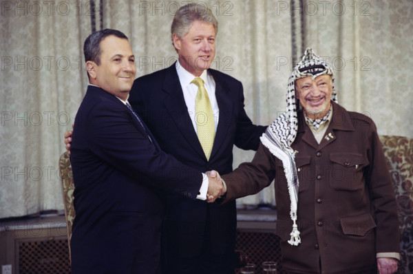 U.S. President Bill Clinton with Prime Minister Ehud Barak of Israel and Chairman Yasser Arafat of the Palestinian Authority as they are shaking hands at trilateral meeting at the U.S. Ambassador's residence in Oslo, Norway, Sharon Farmer, White House photographer, November 2, 1999