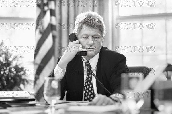 U.S. President Bill Clinton working in the Oval Office of the White House, Washington, D.C., USA, Bob McNeely, White House Photographer, March 3, 1993