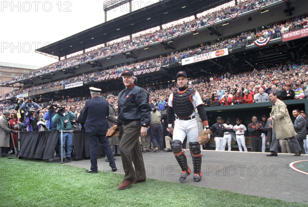 U.S. President Bill Clinton attending opening day baseball game between the Baltimore Orioles and Texas Rangers, Camden Yards Ballpark, Baltimore, Maryland, USA, Bob McNeely, White House Photographer, April 5, 1993