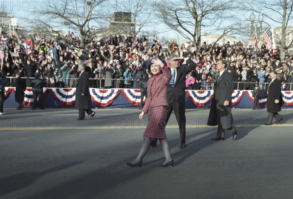 U.S. President Bill Clinton and U.S. First Lady Hillary Rodham Clinton walking along the Inaugural Parade route and waving to the crowd, Washington, D.C., USA, Bob McNeely, White House Photographer, January 20, 1993