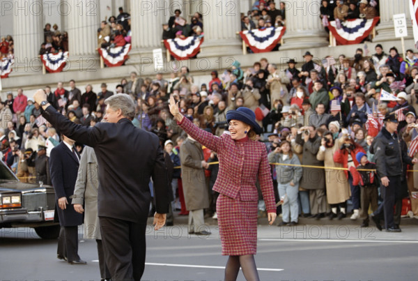 U.S. President Bill Clinton and U.S. First Lady Hillary Rodham Clinton walking along the Inaugural Parade route and waving to the crowd, Washington, D.C., USA, Bob McNeely, White House Photographer, January 20, 1993