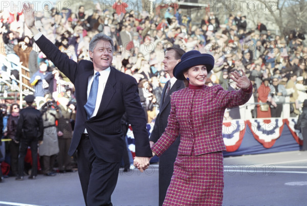 U.S. President Bill Clinton and U.S. First Lady Hillary Rodham Clinton walking along the Inaugural Parade route and waving to the crowd, Washington, D.C., USA, Barbara Kinney, White House Photographer, January 20, 1993