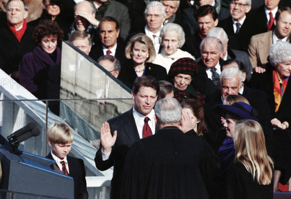 U.S. Vice President-Elect Al Gore being sworn-in by Chief Justice of the U.S. William Rehnquist, as his wife Mary Elizabeth 'Tipper' Gore and others look on during inauguration ceremony, U.S. Capitol, Washington, D.C., USA, Barbara Ellison, White House Photographer, January 20, 1993