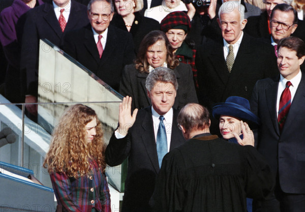 U.S. President-Elect Bill Clinton being sworn-in by Chief Justice of the U.S. William Rehnquist, as Hillary Clinton, daughter Chelsea Clinton and others look on during inauguration ceremony, U.S. Capitol, Washington, D.C., USA, Barbara Ellison, White House Photographer, January 20, 1993