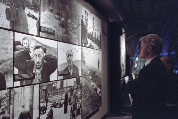 U.S. President Bill Clinton viewing photo exhibit at the Holocaust Museum, Washington, D.C., USA, Ralph Alswang, White House Photographer, April 19, 1993