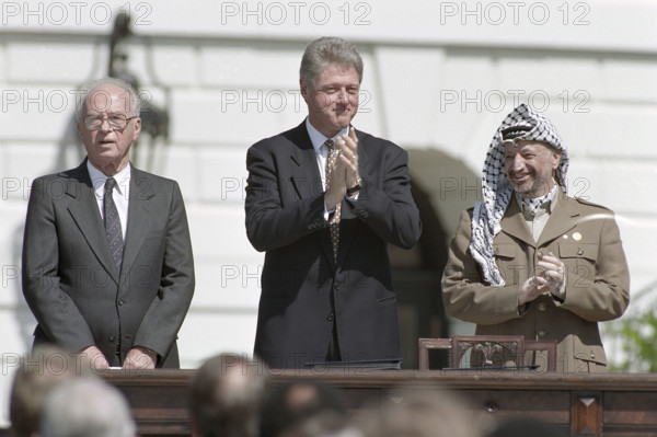 Israeli Prime Minister Yitzhak Rabin, U.S. President Bill Clinton and Palestine Liberation Organization Chairman Yasser Arafat during ceremony for Middle East Peace agreement signing, South Lawn of White House, Washington, D.C., USA, Vince Musi, White House Photographer, September 13, 1993