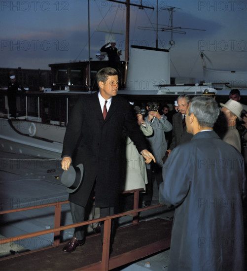 U.S. President John F. Kennedy walking away from Presidential yacht "Honey Fitz" following afternoon meetings with British Prime Minister Harold MacMillan on the Potomac River, Washington, D.C., USA, Robert Knudsen, White House Photographs, April 6, 1961