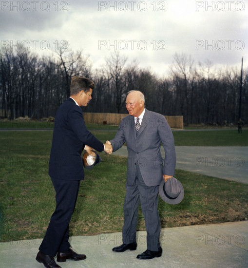 U.S. President John F. Kennedy shaking hands with former U.S. President Dwight D. Eisenhower, Camp David, Frederick County Maryland, USA, Robert Knudsen, White House Photographs, April 22, 1961