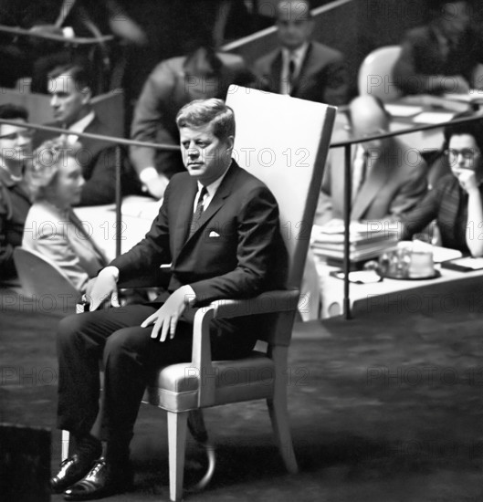 U.S. President John F. Kennedy sitting in chair on platform before General Assembly of the United Nations, General Assembly Hall, United Nations Headquarters, New York City, New York, USA, Cecil Stoughton, White House Photographs, September 25, 1961