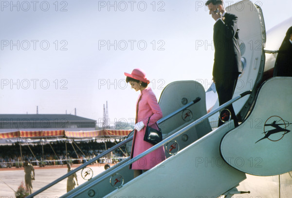 U.S. First Lady Jacqueline Kennedy and U.S. Ambassador to India John Kenneth Galbraith walking down airplane stairs upon arrival at Palam Airport, New Delhi, India, Cecil Stoughton, White House Photographs, March 12, 1962