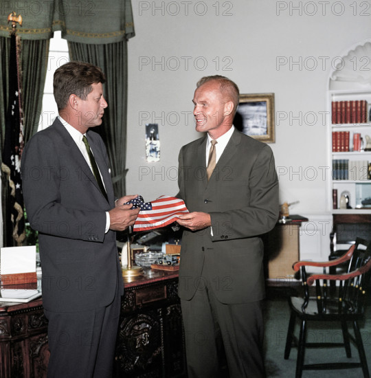 U.S. President John F. Kennedy receiving gift of an American flag from astronaut Lieutenant Colonel John H. Glenn, Jr., Ovla Office, White, House, Washington, D.C., USA,  Robert Knudsen, White House Photographs, June 27, 1962