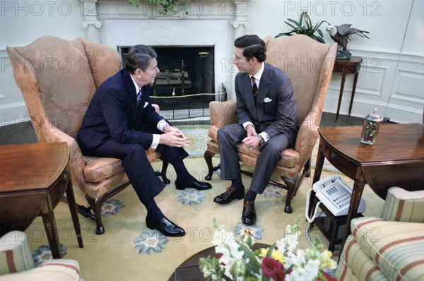 U.S. President Ronald Reagan sitting by fireplace with Prince Charles during visit in the  Oval Office of the White House, Washington, D.C., USA, President Ronald Reagan White House Photographic Office, May 1, 1981