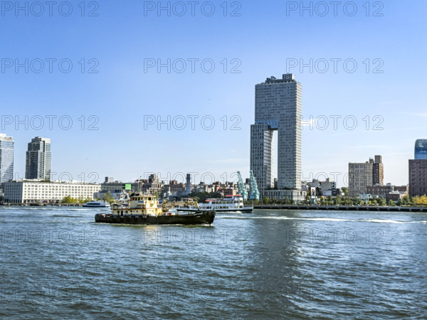Circle Line ferry and tugboat in East River against Williamsburg cityscape, Brooklyn, New York City, New York, USA