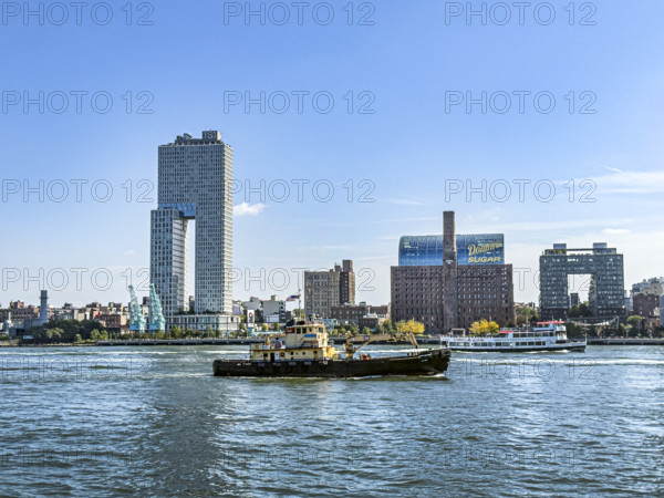 Circle Line ferry and tugboat in East River against Williamsburg cityscape, Brooklyn, New York City, New York, USA