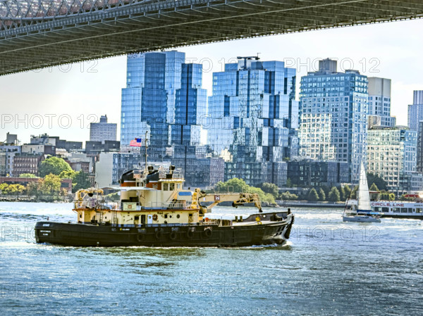 Tugboat in East River with Williamsburg cityscape in background, Brooklyn, New York City, New York, USA