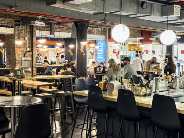 Group of people eating at casual restaurant, Dickson's Farmstand Meats, Chelsea Market, Ninth Avenue, Chelsea, Manhattan, New York City, New York, USA