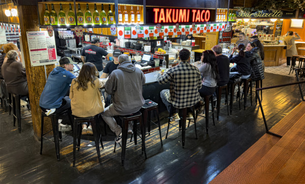 Group of people eating at casual restaurant, Takumi Taco, Chelsea Market, Ninth Avenue, Chelsea, Manhattan, New York City, New York, USA