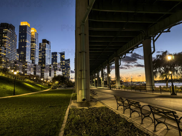 Pedestrian and bicycle paths underneath West Side Highway at night, Riverside Park South, Upper West Side, Manhattan, New York City, New York, USA