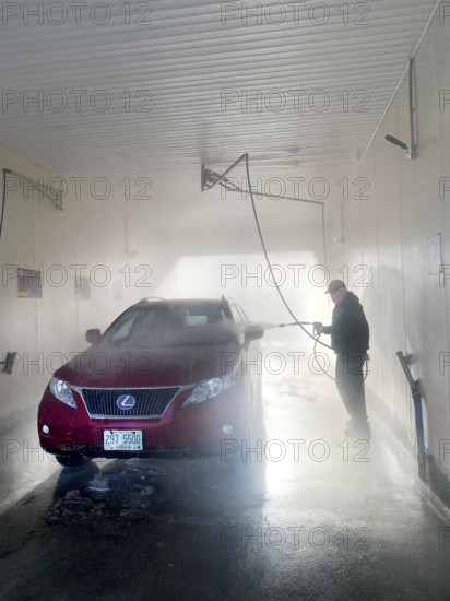 Man washing car at self-service car wash