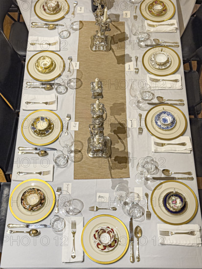High angle view of dining room table set for formal dinner
