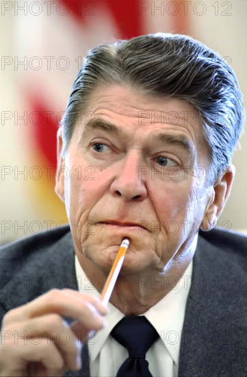 Head and shoulders portrait of U.S. President Ronald Reagan during meeting with members of congress in the Cabinet Room of the White House, Washington, D.C., USA, President Ronald Reagan White House Photographic Office, November 1, 1983