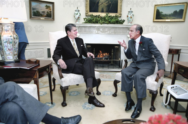U.S. President Ronald Reagan meeting with Canadian Prime Minister Pierre Trudeau in the Oval Office of the White House, Washington, D.C., USA, President Ronald Reagan White House Photographic Office, December 15, 1983