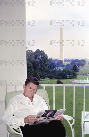 U.S. President Ronald Reagan reading Washington Star newspaper on the Truman balcony, White House, Washington, D.C., USA, President Ronald Reagan White House Photographic Office, June 23, 1981