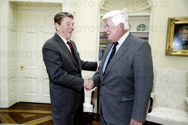 U.S. President Ronald Reagan with Speaker of The House Thomas P. "Tip" O'Neill, Jr. in Oval Office of the White House, Washington, D.C., USA, President Ronald Reagan White House Photographic Office, March 7, 1985