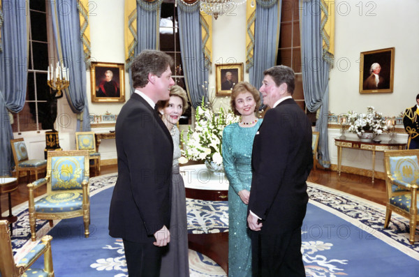 U.S. President Ronald Reagan,  U.S. First Lady Nancy Reagan, Arkansas governor Bill Clinton and Hillary Clinton in the White House Blue Room during a dinner honoring the nation's governors, Washington, D.C., USA, President Ronald Reagan White House Photographic Office, February 22, 1987