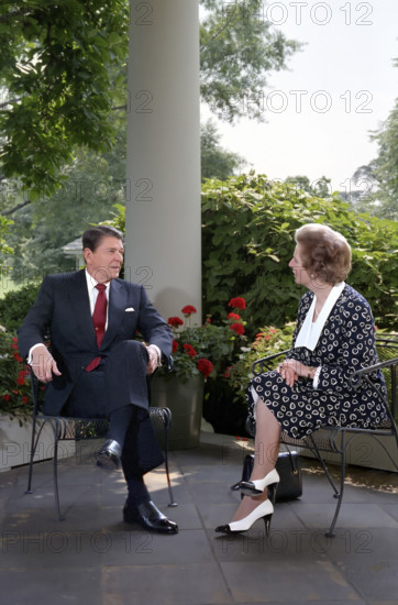 U.S. President Ronald Reagan and British Prime Minister Thatcher talk on patio outside White House Oval Office, Washington, D.C., USA, President Ronald Reagan White House Photographic Office, July 17, 1987